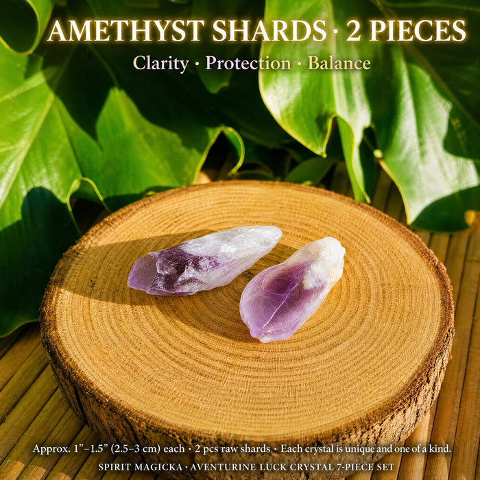 Two raw amethyst shards with deep purple tips on a wood round