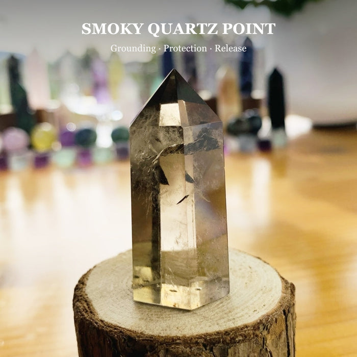 A smoky quartz point on a wood round