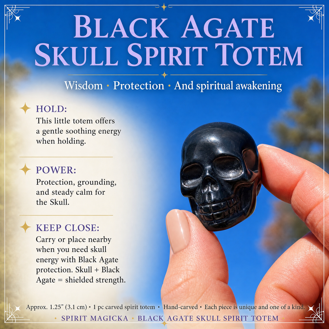 A small glossy black agate skull held between fingertips against a blue sky