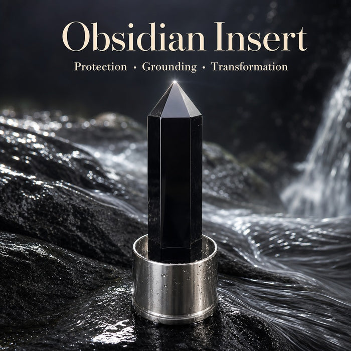 Black obsidian insert on a dark wet rock in front of a waterfall