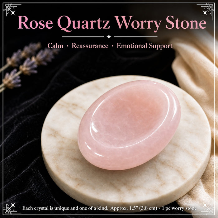 Smooth pink rose quartz worry stone with a thumb groove on a stone dish