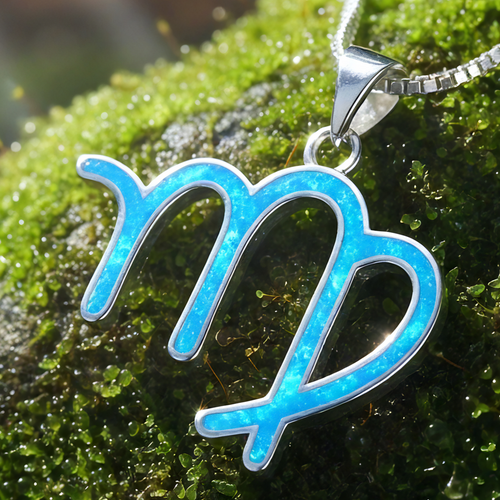 Close-up of the Virgo glyph pendant inlaid with blue opal in a sterling silver setting