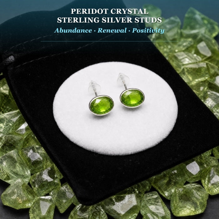 Pair of green peridot stud earrings on a display card