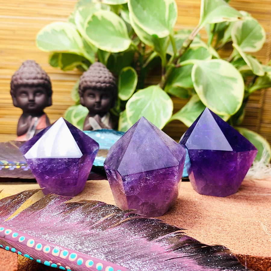 Three amethyst freeform points side by side, each a slightly different shape and shade of purple