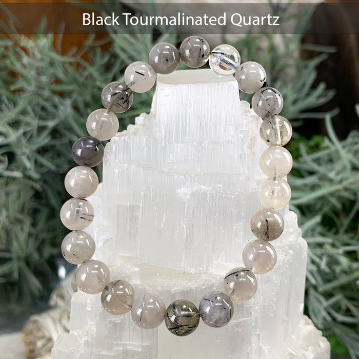 Black tourmalinated quartz bead bracelet with dark needles inside pale quartz