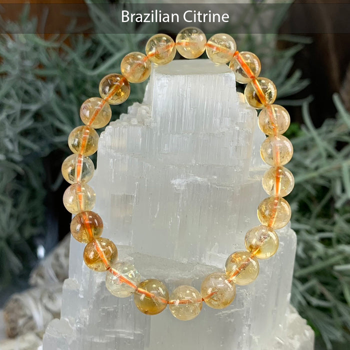 Golden Brazilian citrine bead bracelet on a selenite tower