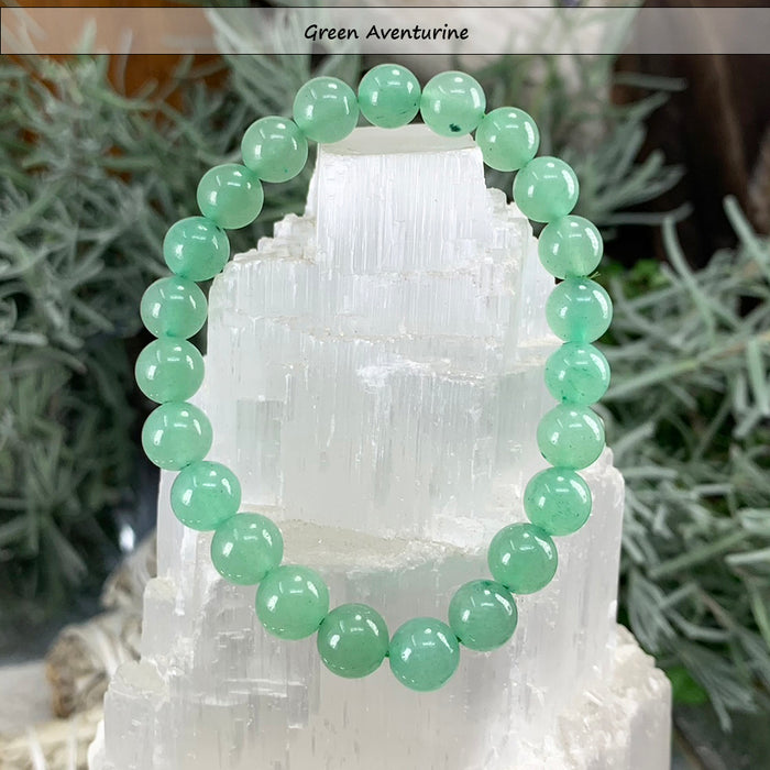 Green aventurine bead bracelet on a selenite tower