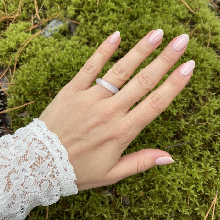 Pink agate ring worn on a ring finger